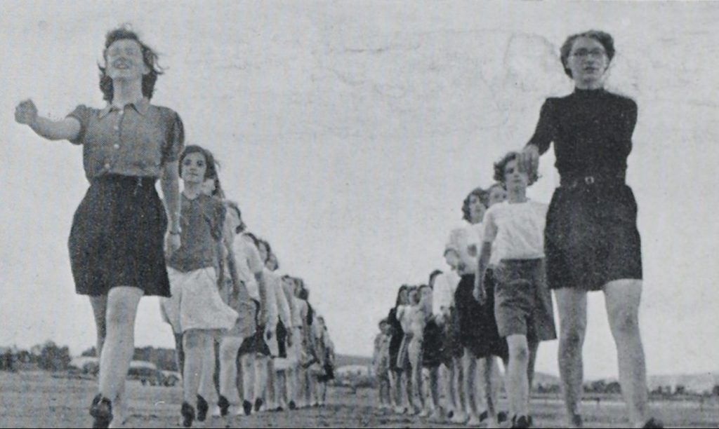 Two lines of female Cadets march in unison towards the viewer.